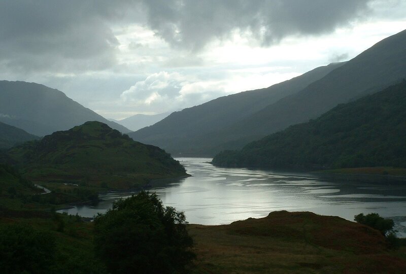 mountain lake under cloudy sky