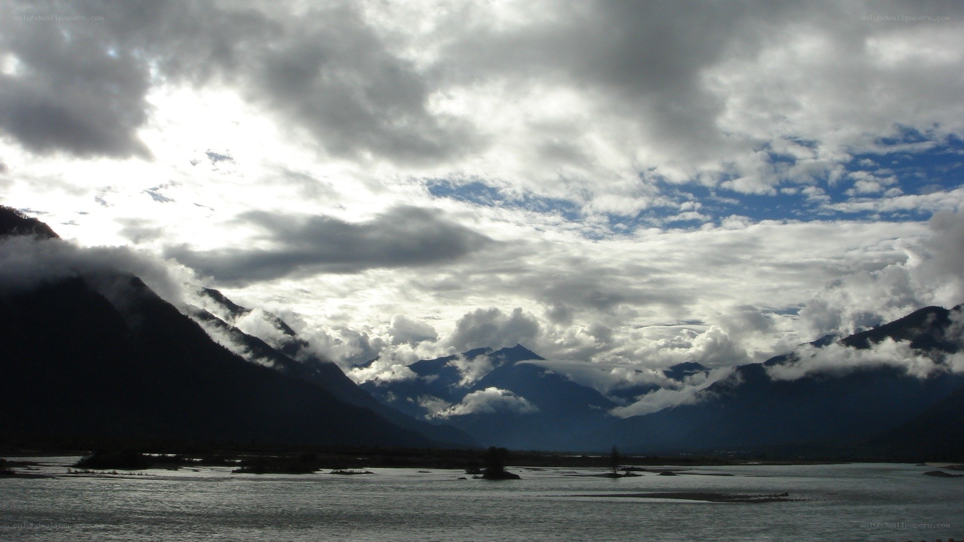 Mountain lake under cloudy sky