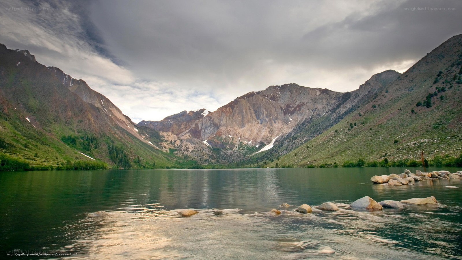 Mountain lake under cloudy sky