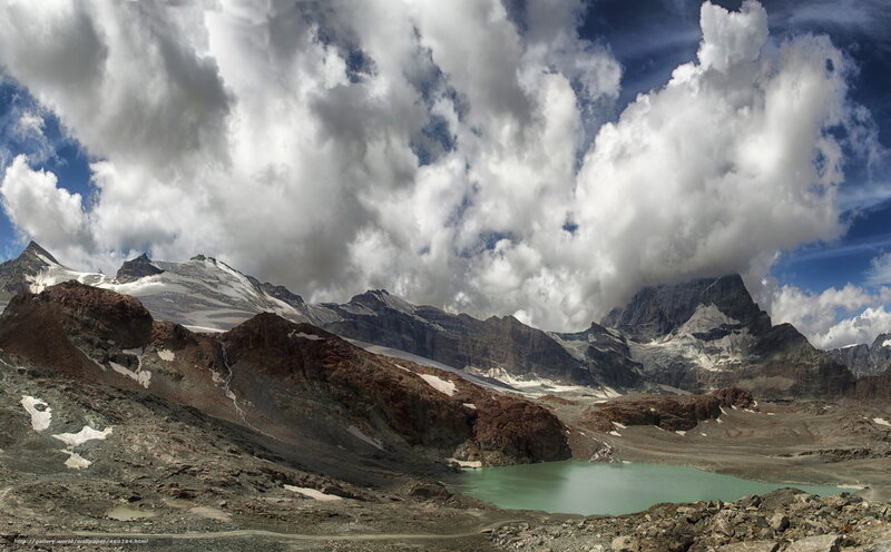 Mountain lake under cloudy sky