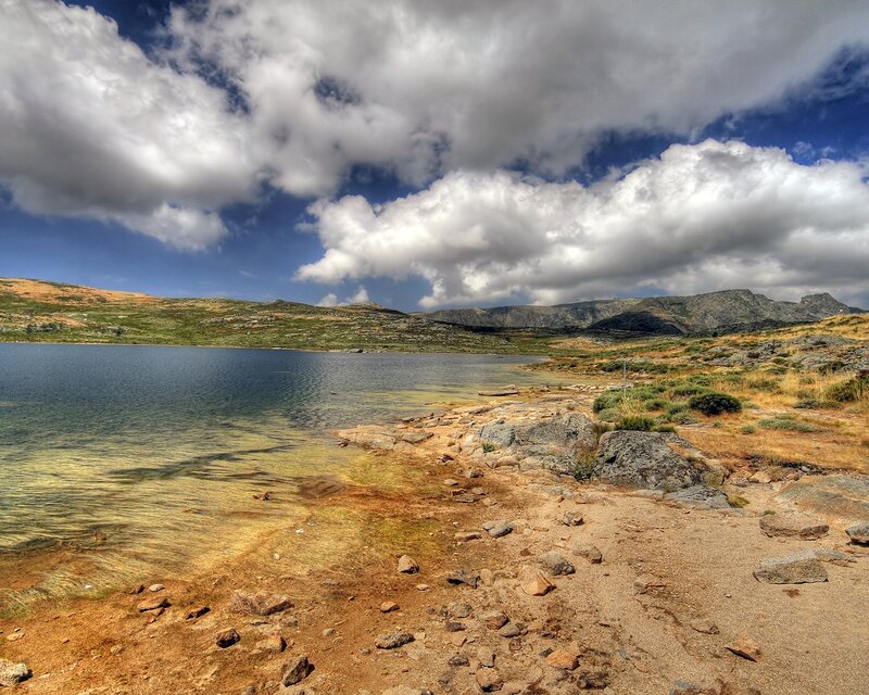 Mountain lake under cloudy sky