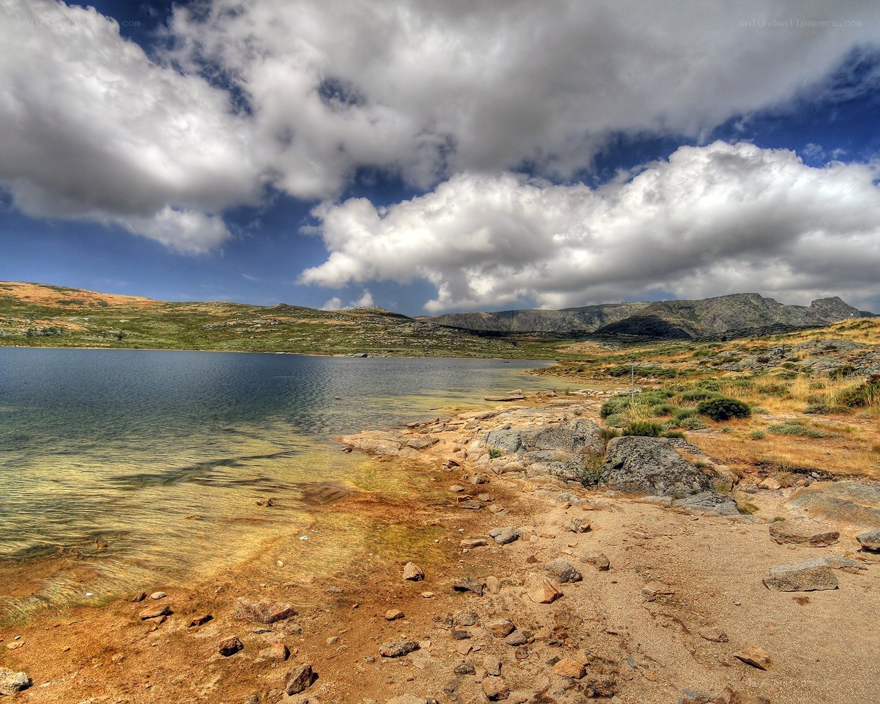 Mountain lake under cloudy sky