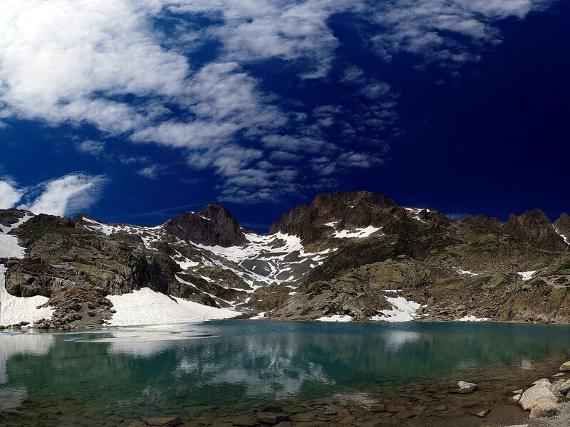 Mountain lake under cloudy sky