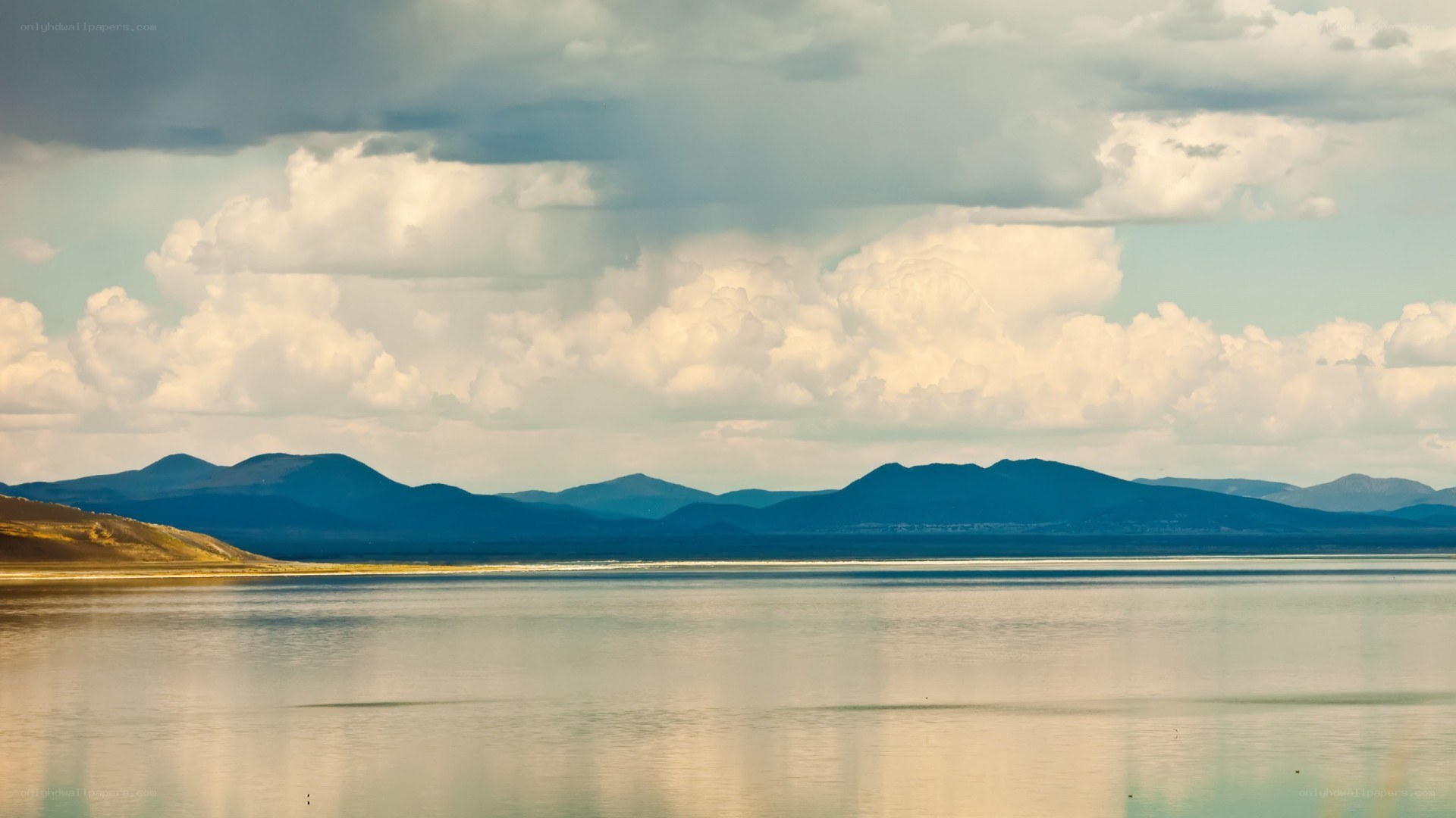 Mountain lake under cloudy sky