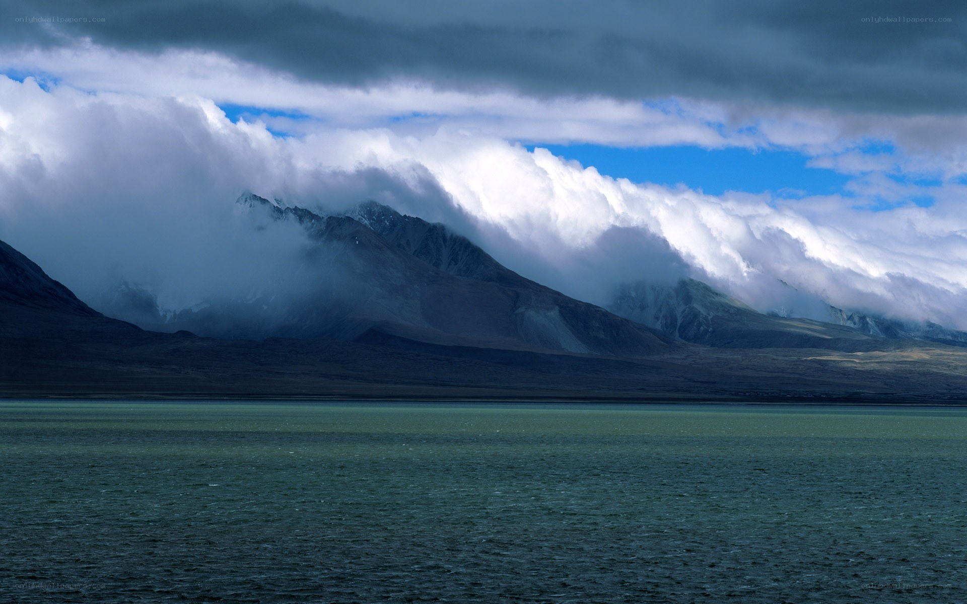 Mountain lake under cloudy sky