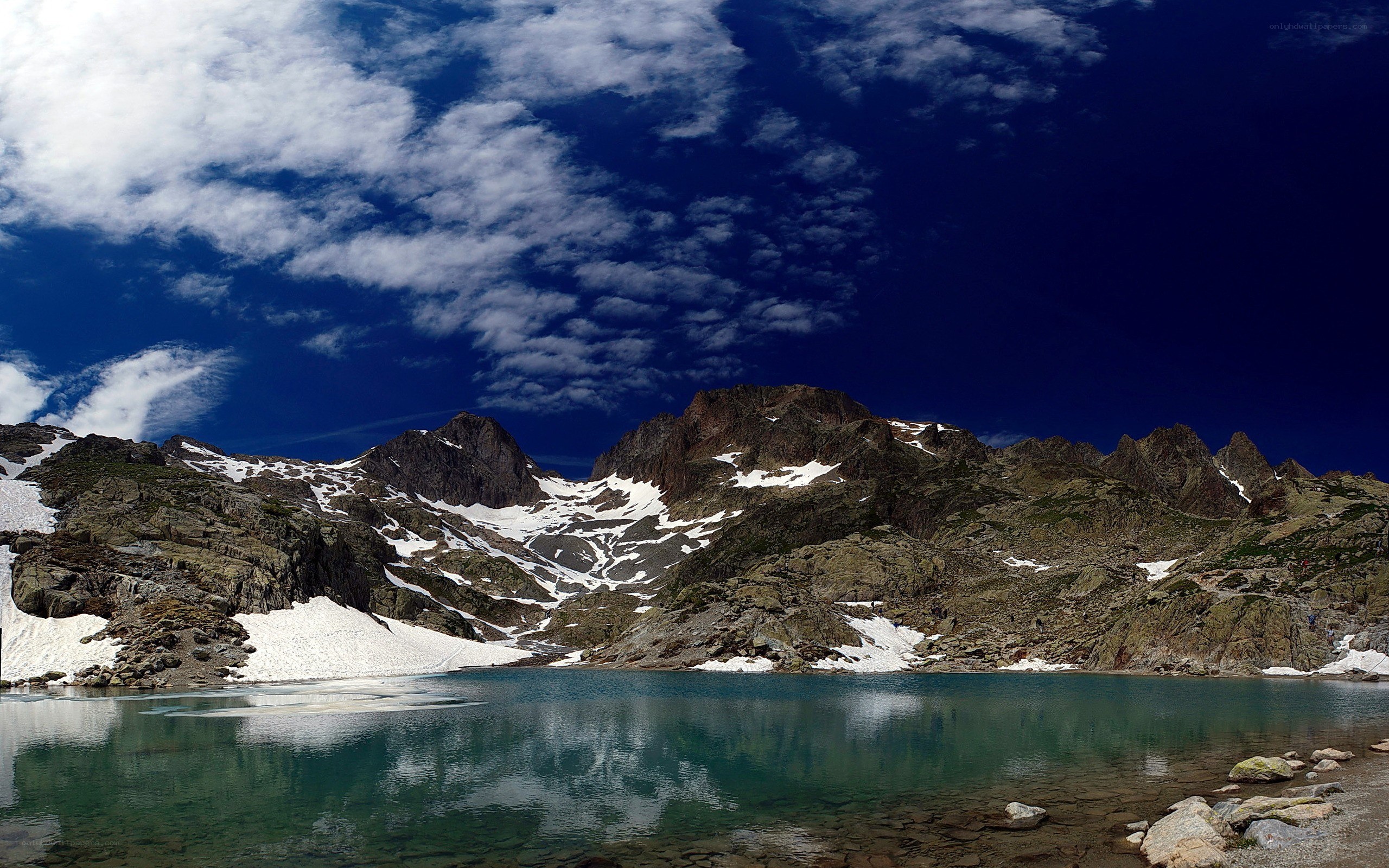 Mountain lake under cloudy sky