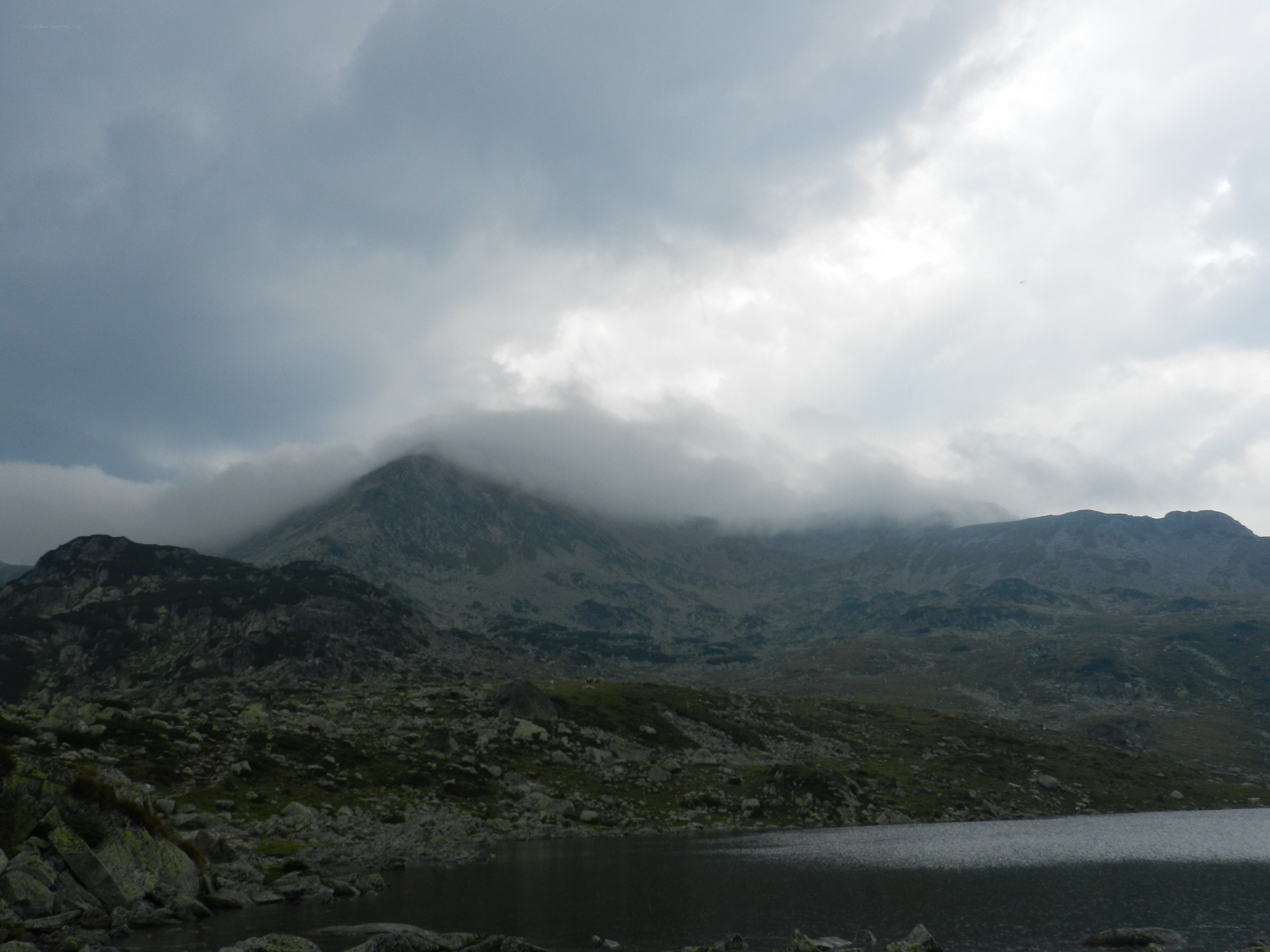 Mountain lake under cloudy sky