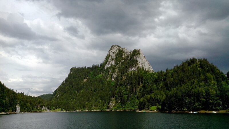 Mountain lake under cloudy sky