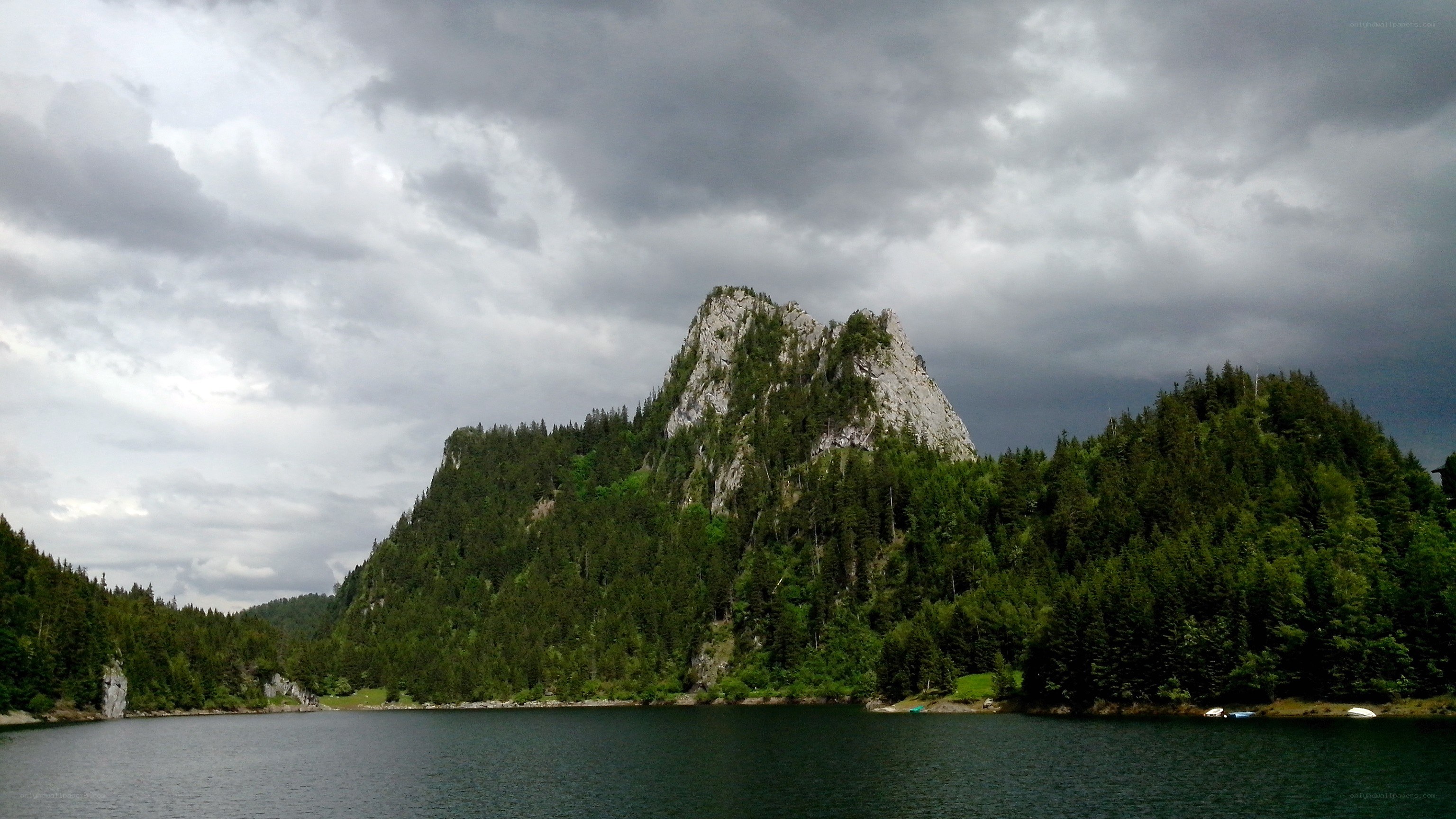 Mountain lake under cloudy sky
