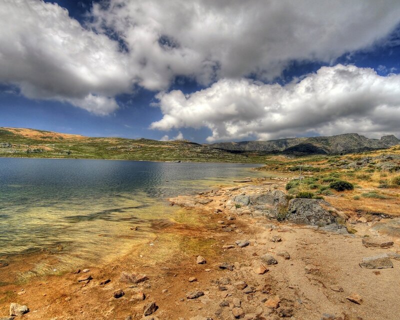 Mountain lake under cloudy sky