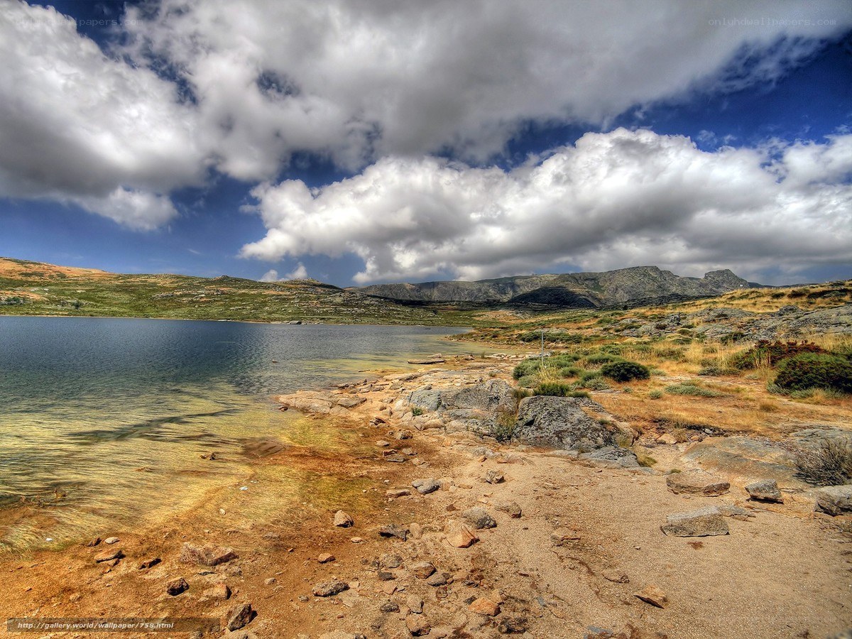 Mountain lake under cloudy sky