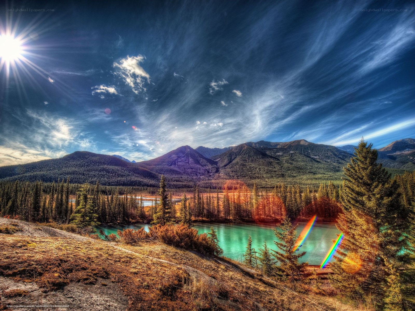 Mountain lake under starburst sky
