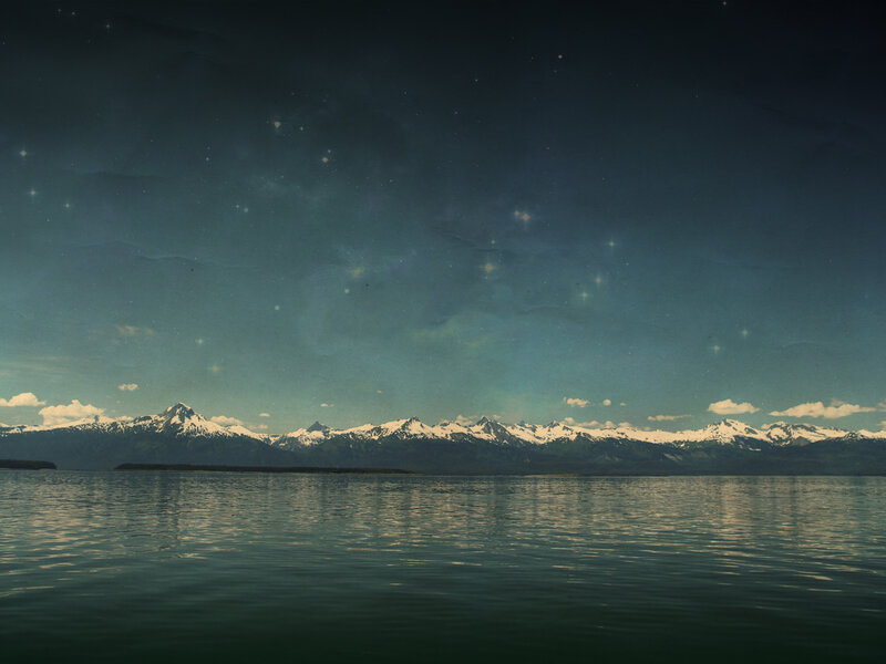 Mountain lake under starry sky