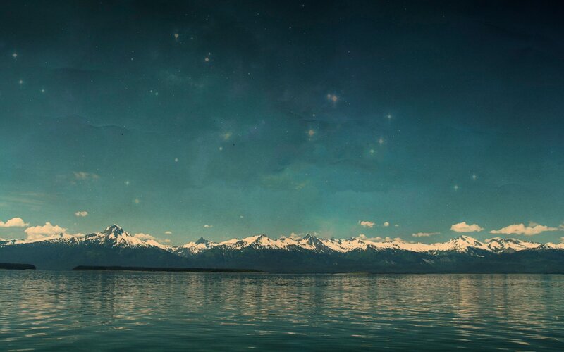 Mountain lake under starry sky