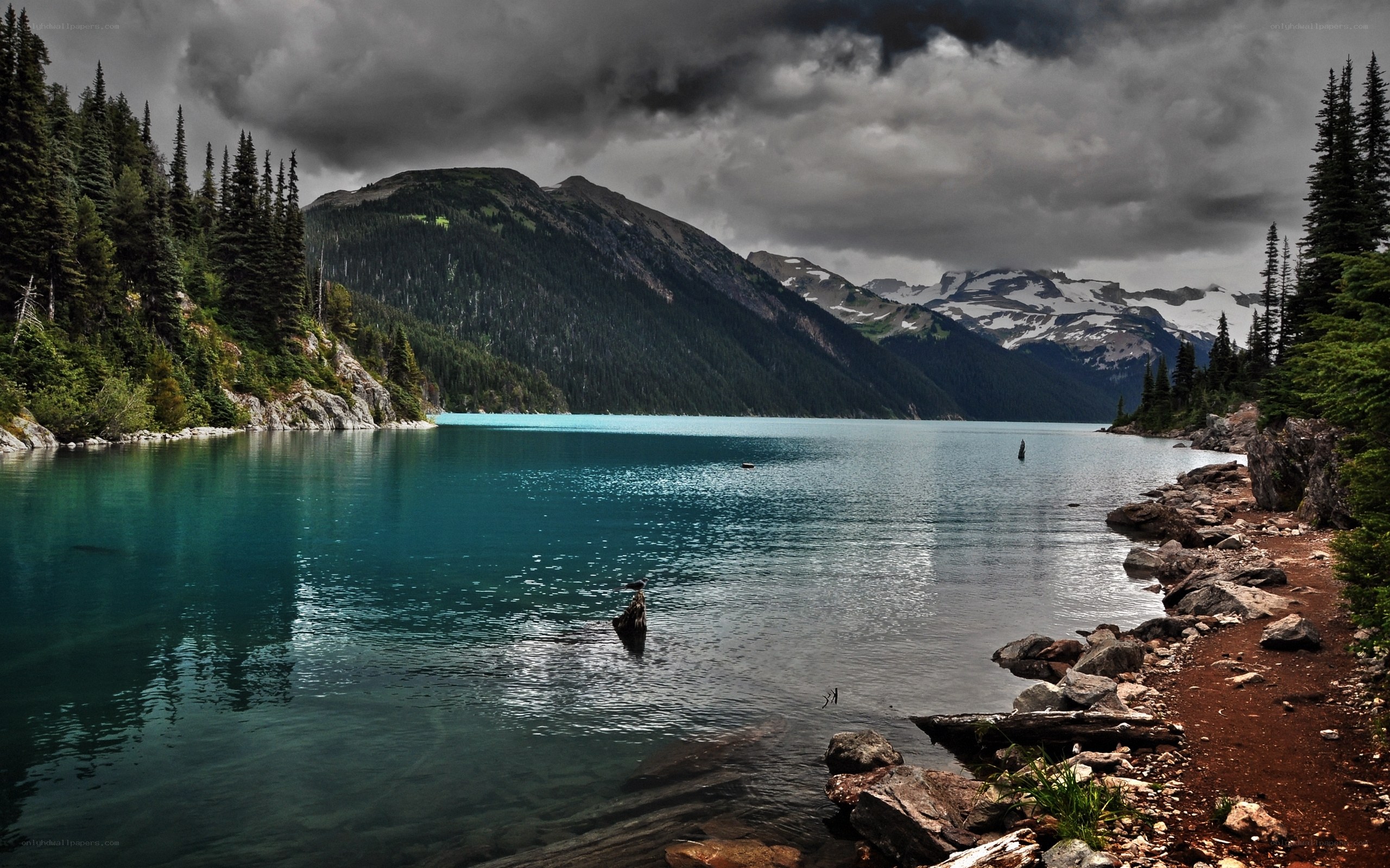 Mountain lake under stormy sky