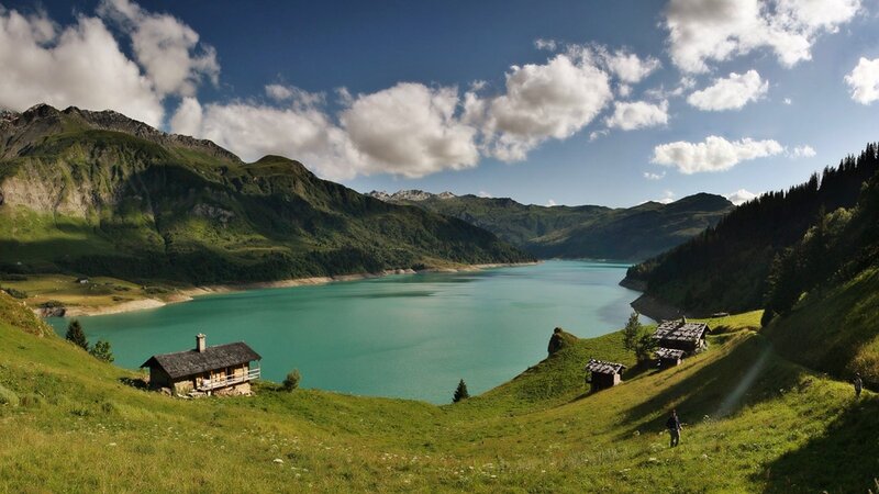 Mountain lake with alpine huts