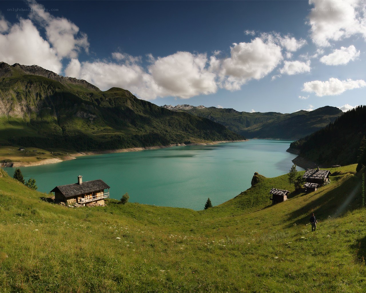 Mountain lake with alpine huts