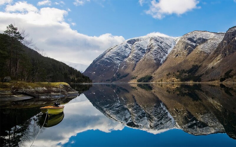 Mountain lake with boat reflection