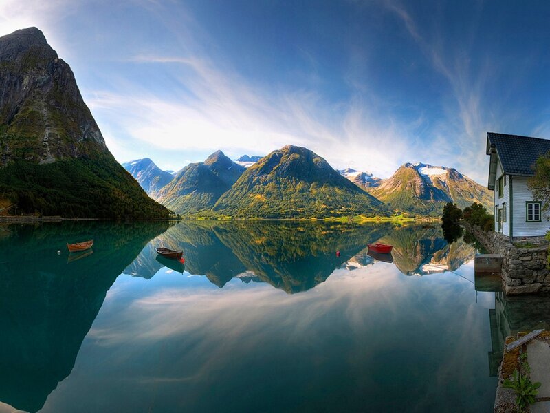 Mountain lake with boat reflections