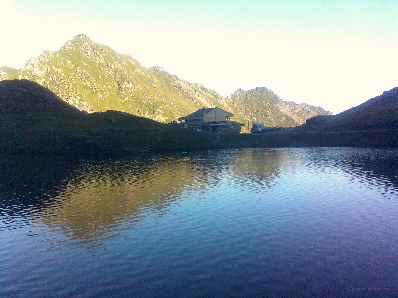 mountain lake with cabin