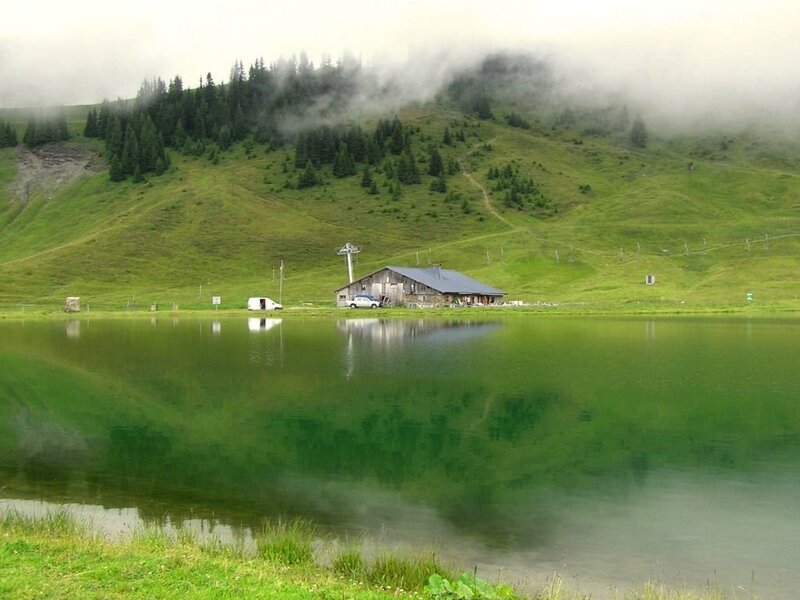 Mountain lake with cabin and fog