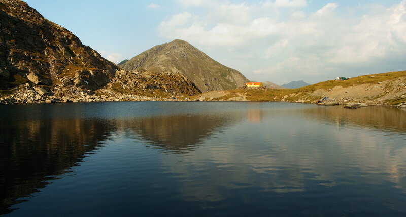 Mountain Lake with Cabin — Blue, Serene, Afternoon, Photograph, Mountains