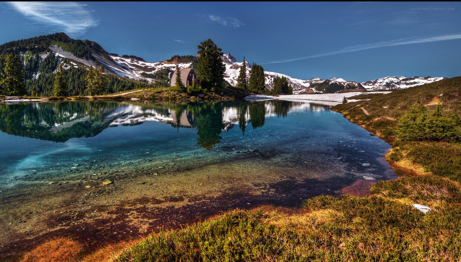 Mountain lake with cabin reflection