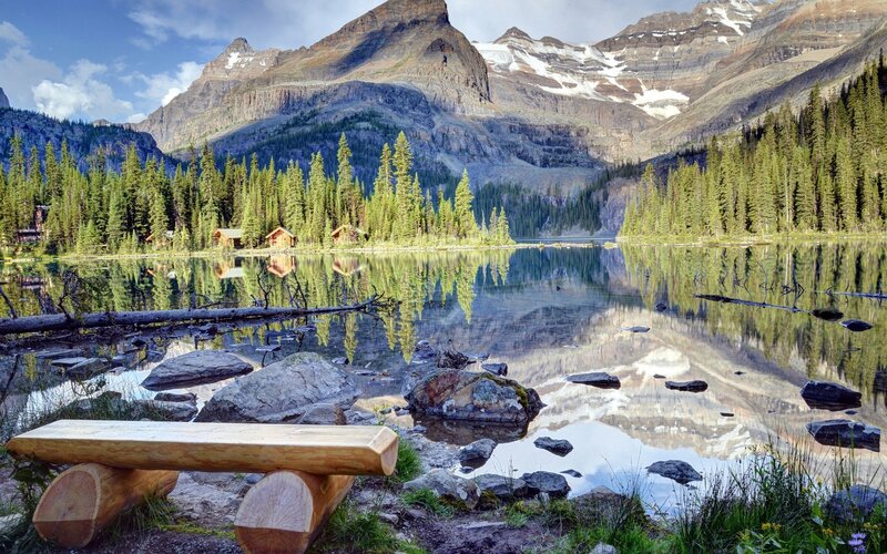 Mountain lake with cabin reflection