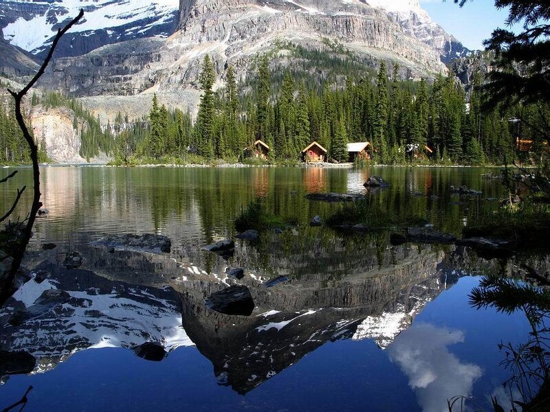 Mountain lake with cabin reflection