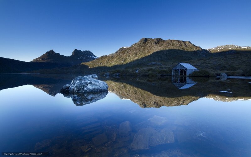 Mountain lake with cabin reflection