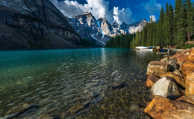 Mountain Lake with Canoes — Blue, Serene, Afternoon, Photograph, Pine Trees