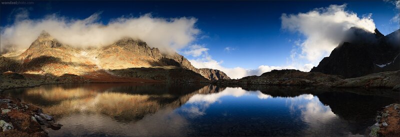 Mountain lake with cloud reflections
