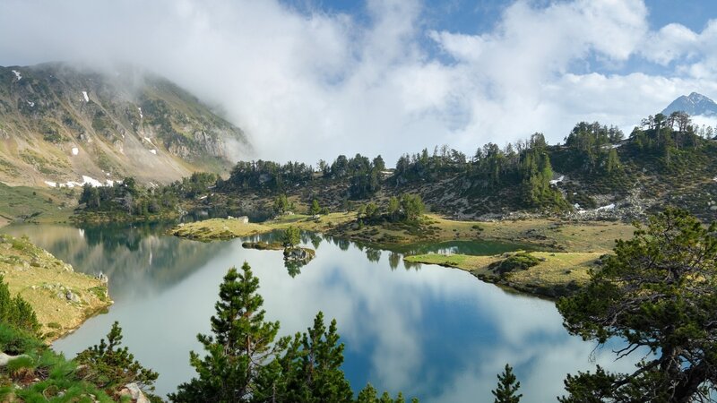 Mountain lake with cloud reflections
