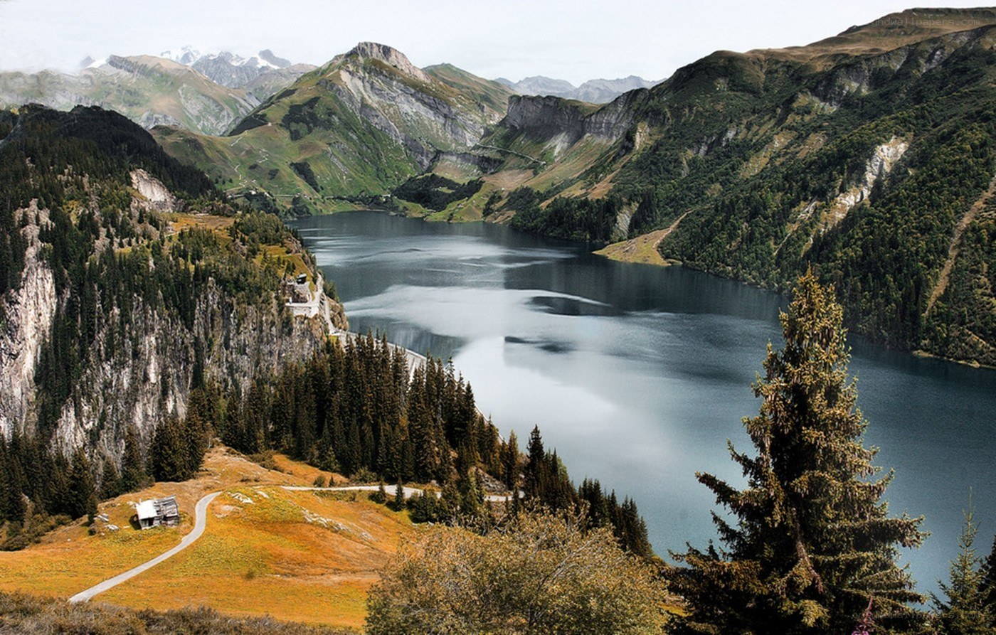 Mountain lake with dam and forest