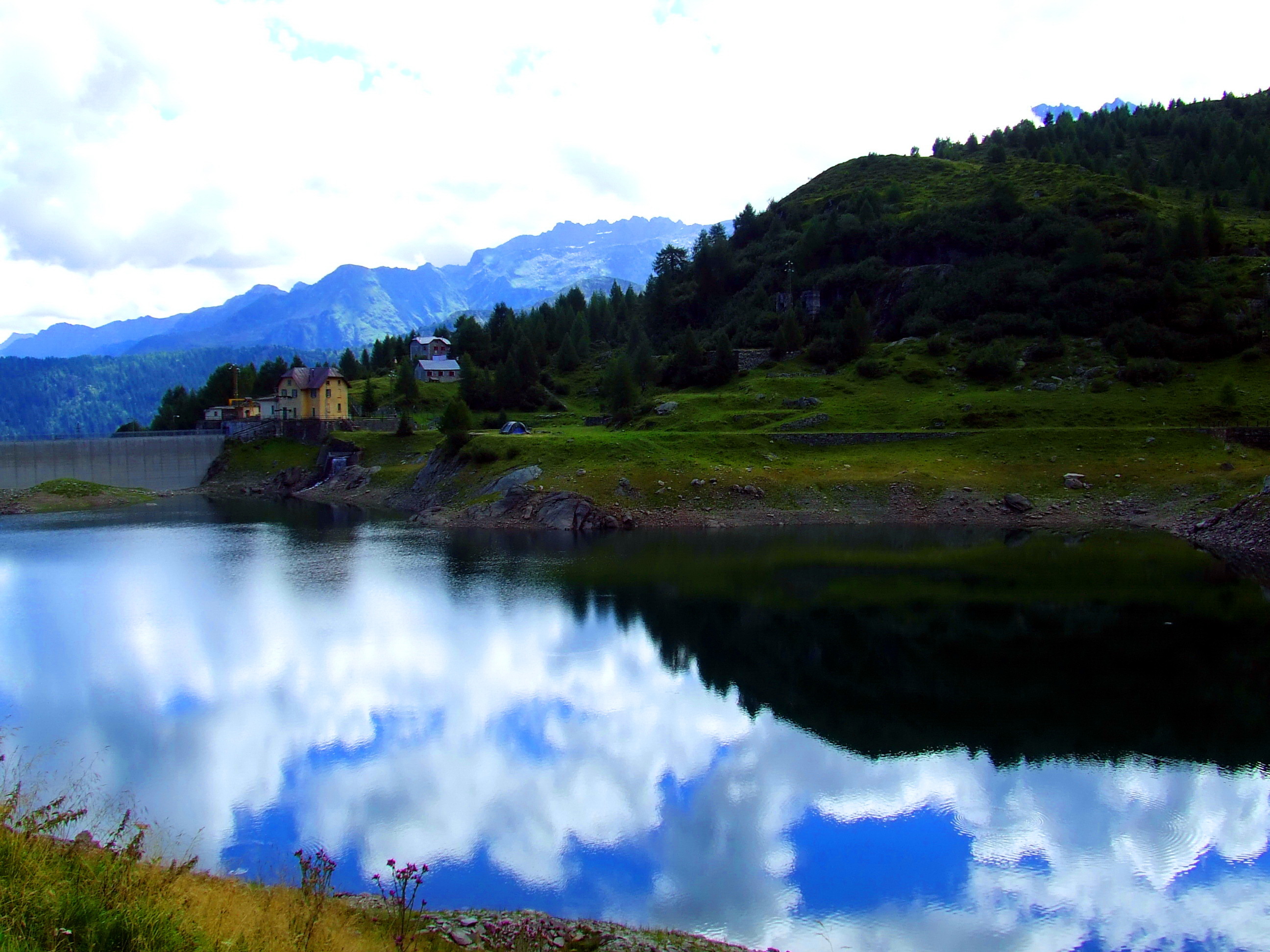 Mountain lake with dam and reflection