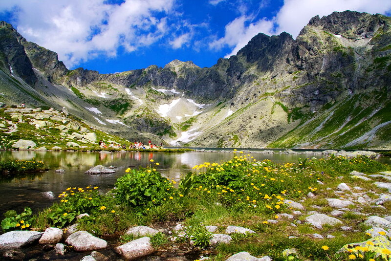 Mountain Lake with Flowers — Blue, Serene, Summer, Photograph, Rocks, People