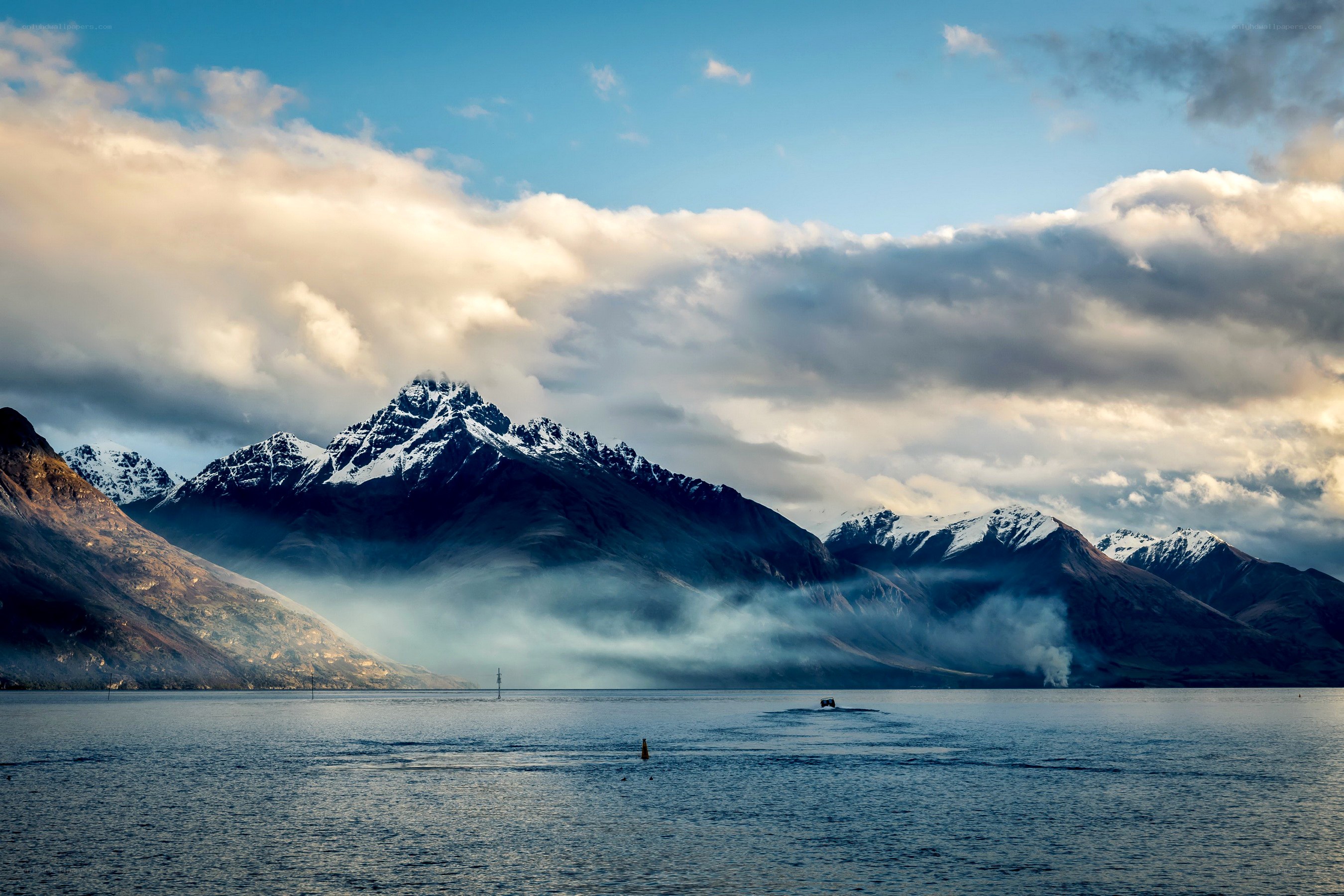 Mountain lake with fog and clouds