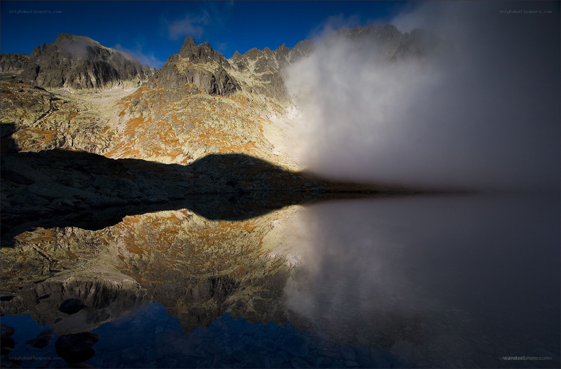 Mountain lake with fog reflection