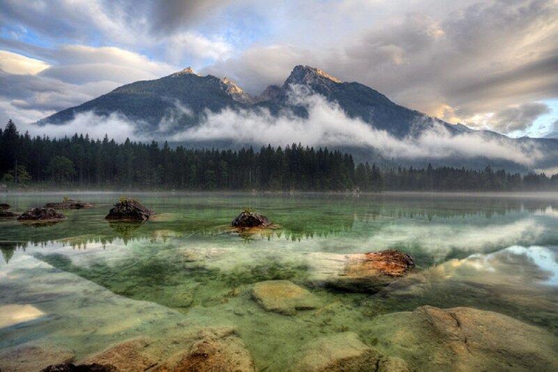 Mountain lake with foggy peaks