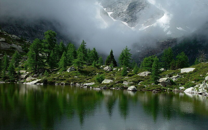 Mountain lake with foggy peaks