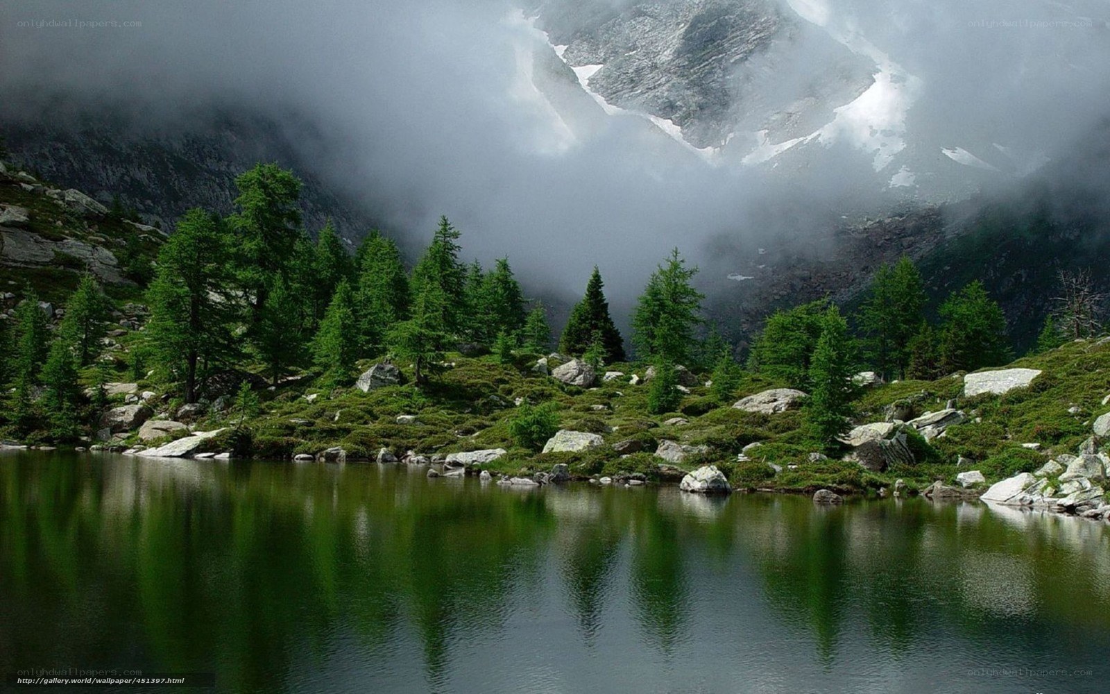 Mountain lake with foggy peaks
