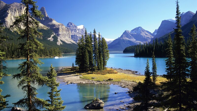 Mountain lake with forest and boat