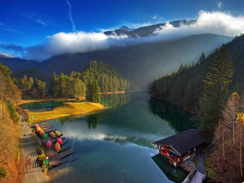 Mountain lake with forest and cabin