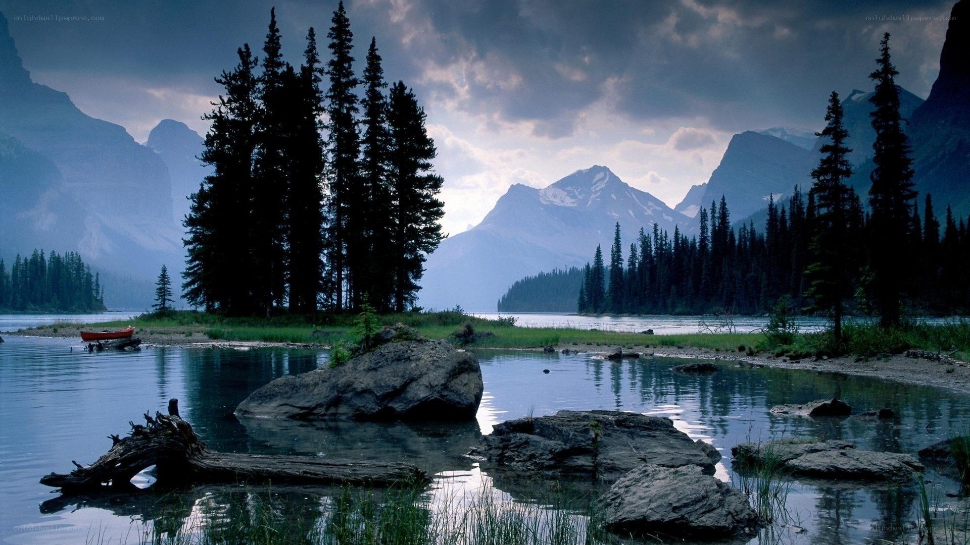 Mountain lake with forest and canoe