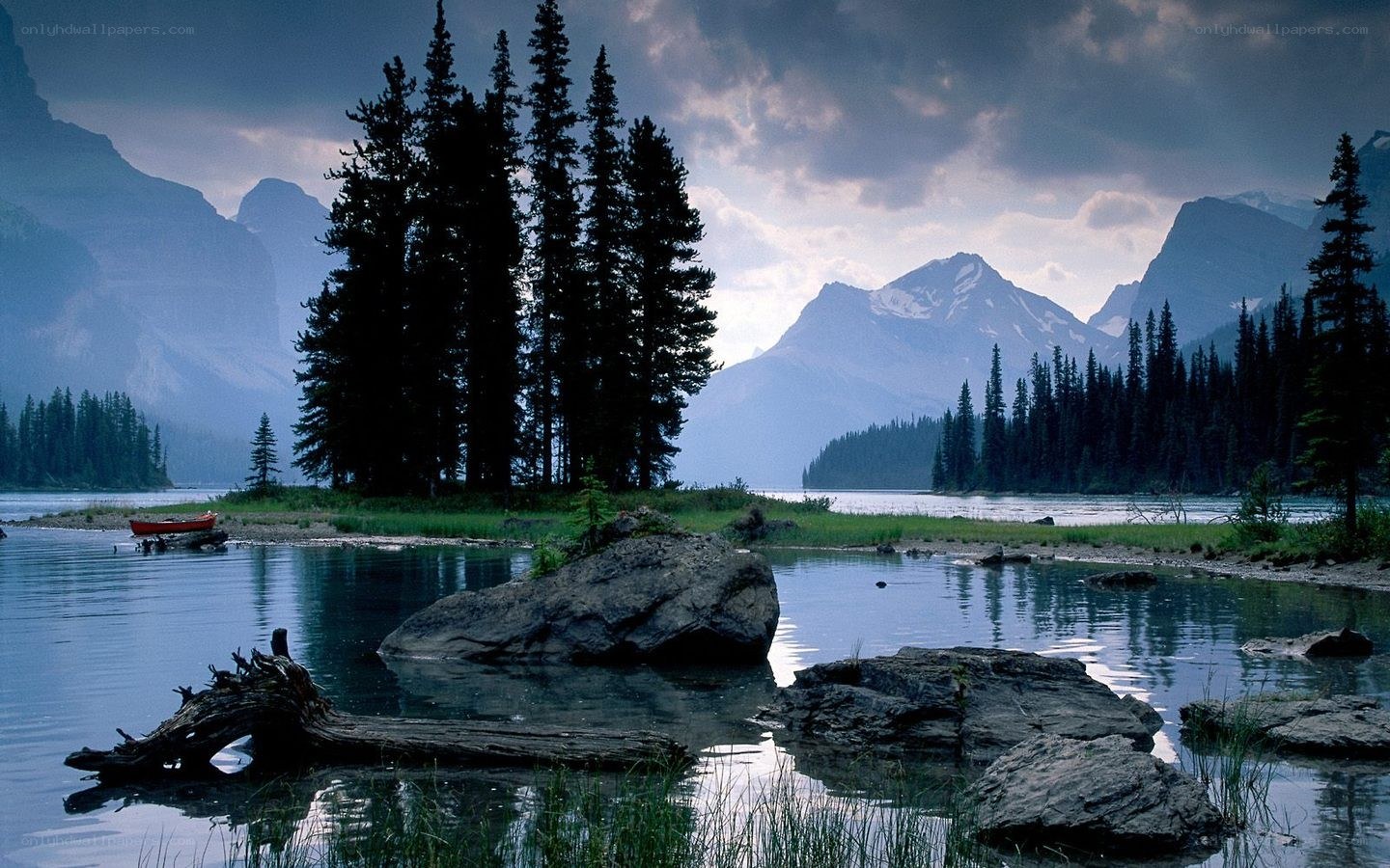 Mountain lake with forest and canoe
