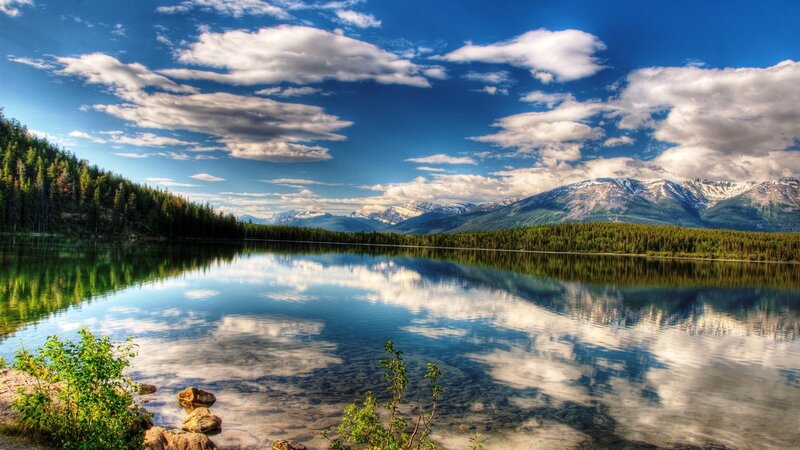 Mountain lake with forest and clouds