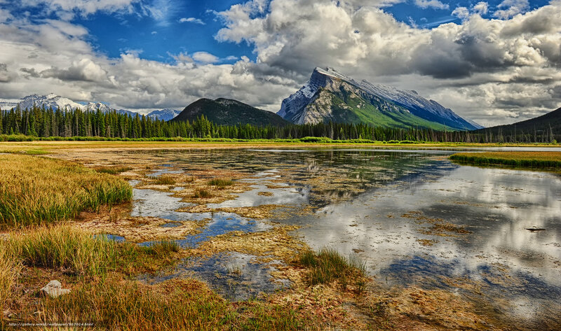 Mountain lake with forest and clouds