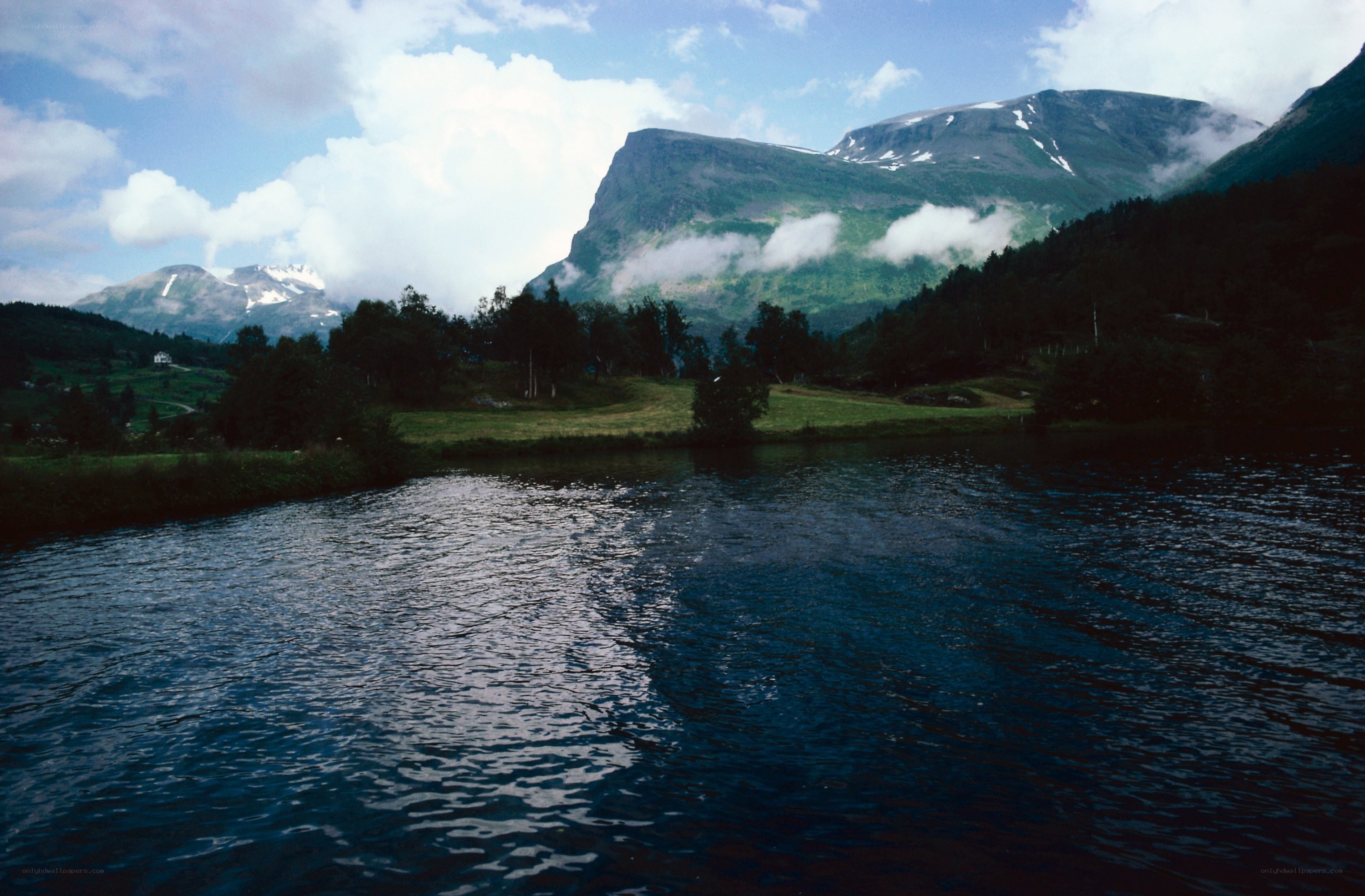 Mountain lake with forest and clouds
