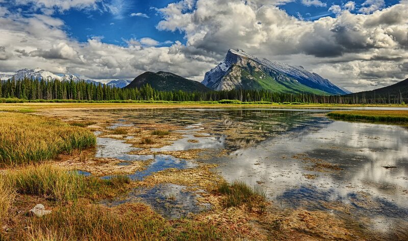 Mountain lake with forest and clouds