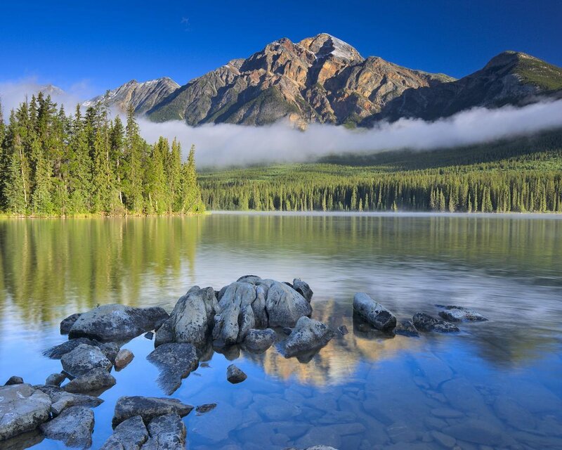 Mountain lake with forest and fog